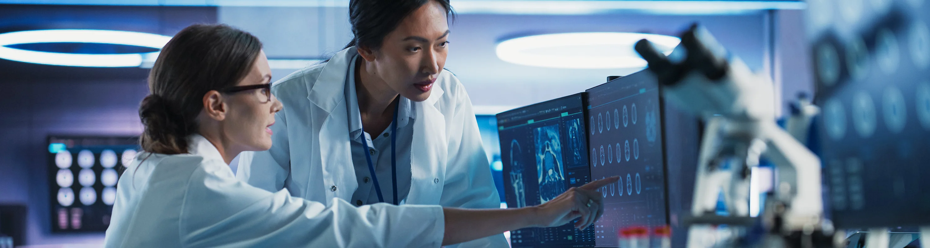 Scientists discussing data on a computer screen in a modern laboratory.