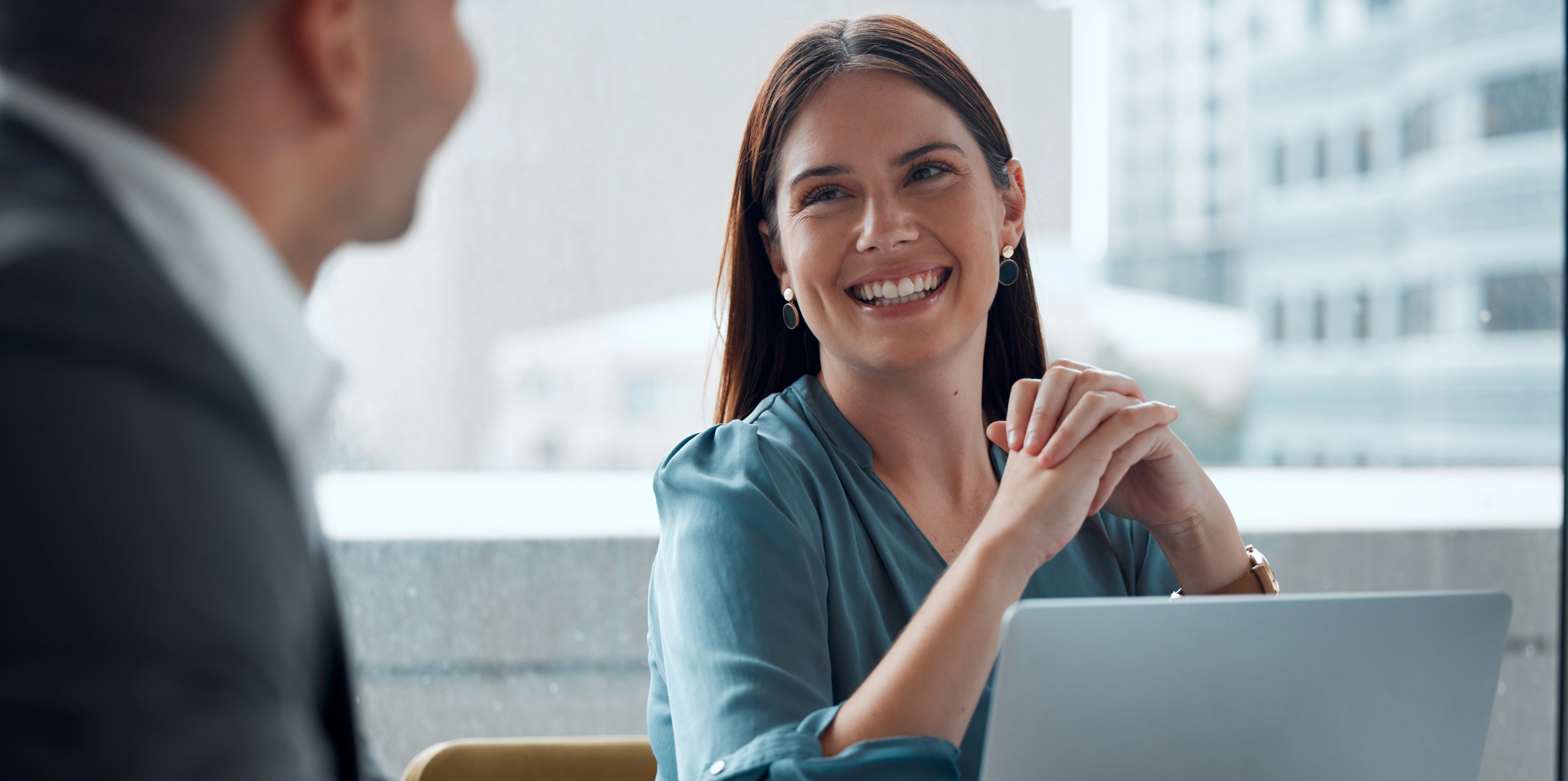 Business meeting, woman and happy with laptop, working in company office, building or teamwork discussion. Female employee, manager or conversation with executive, ceo or feedback from boss Business meeting, woman and happy with laptop, working in company office, building or teamwork discussion. Female employee, manager or conversation with executive, ceo or feedback from boss
