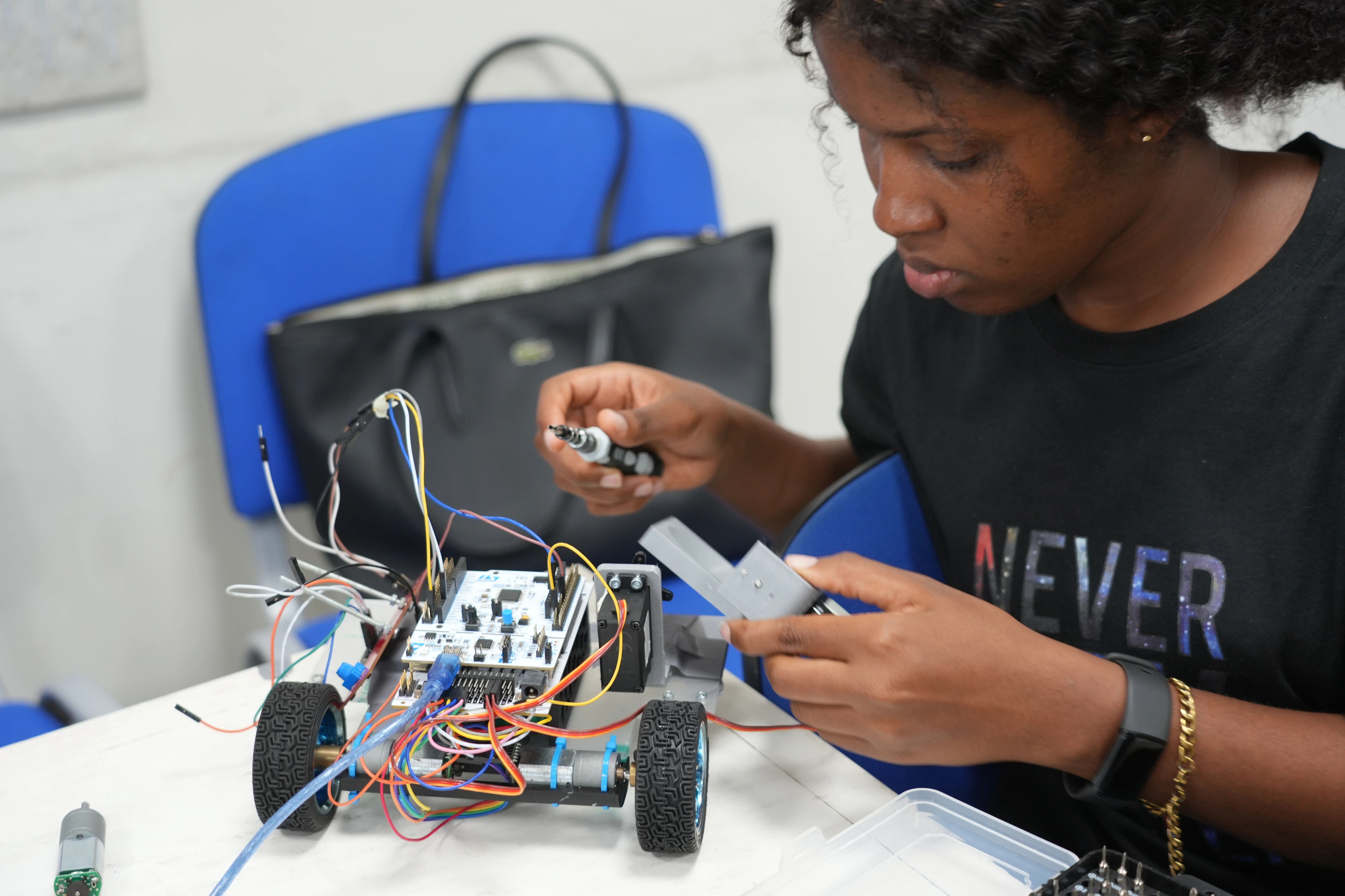 Eine Studierende baut an ihrem Roboter.