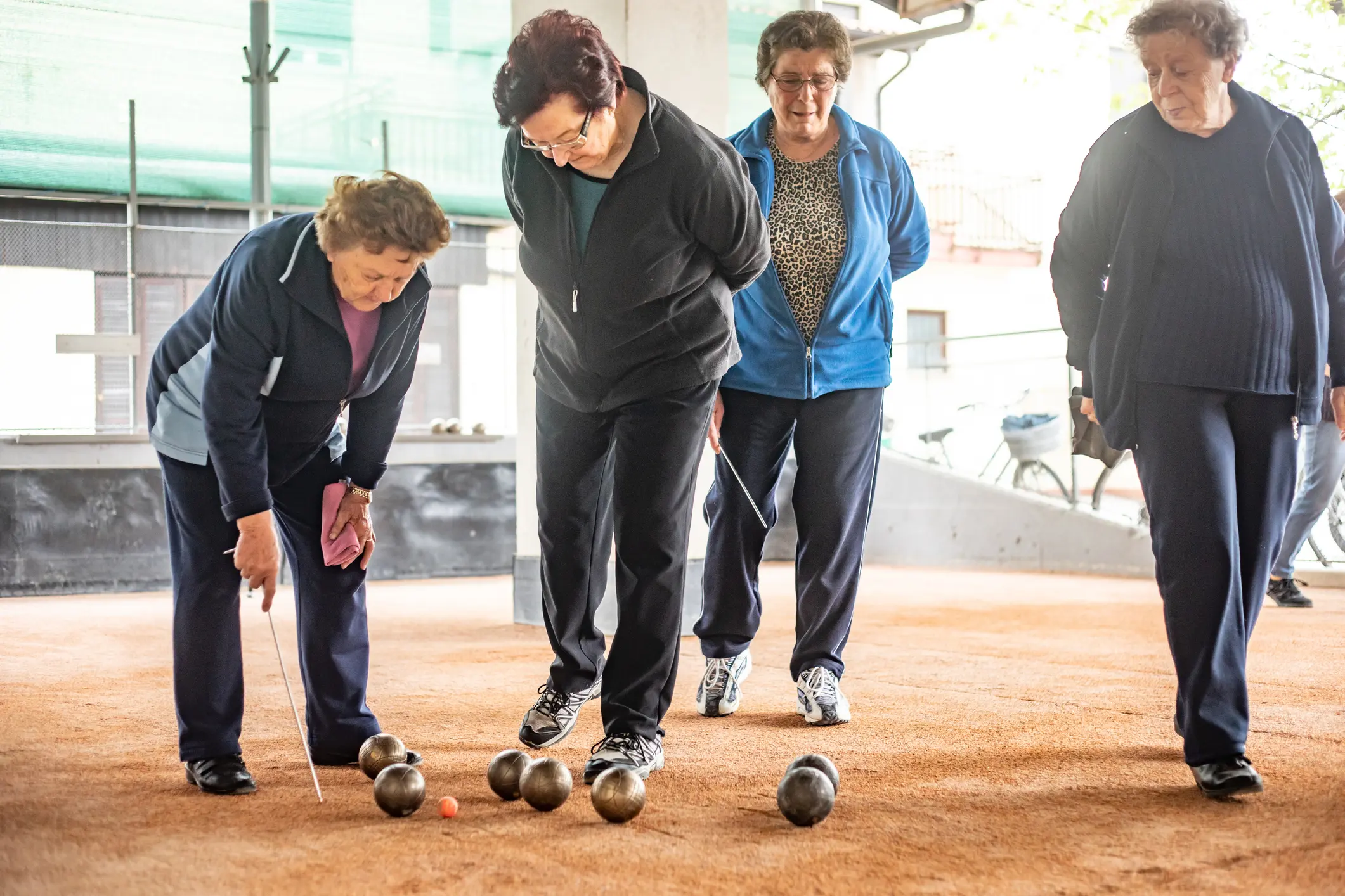 Senior Woman Marking Where Bocce Ball Has Stopped Senior Woman Marking Where Bocce Ball Has Stopped
