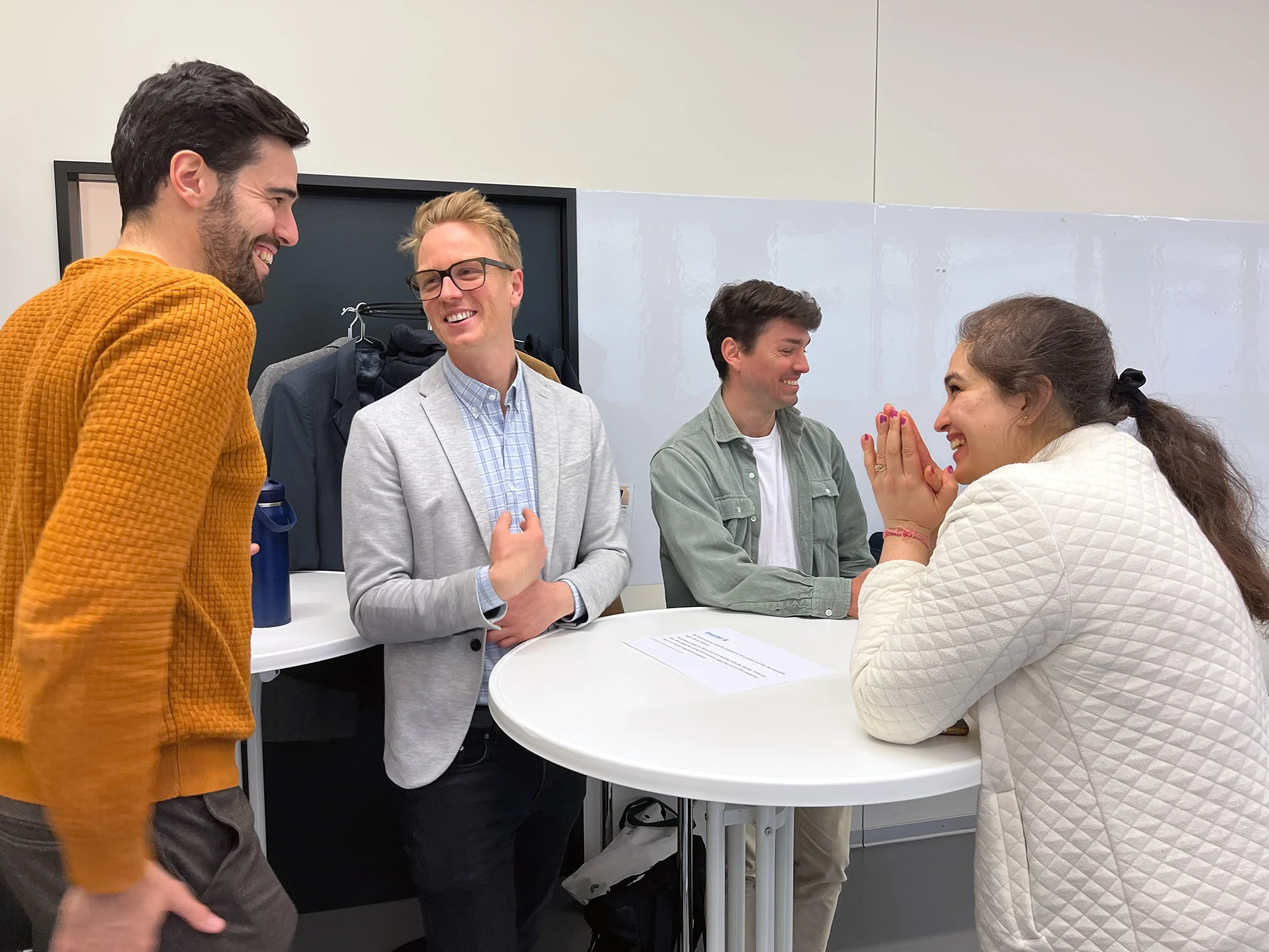 Four AIT India participants are discussing at a table.