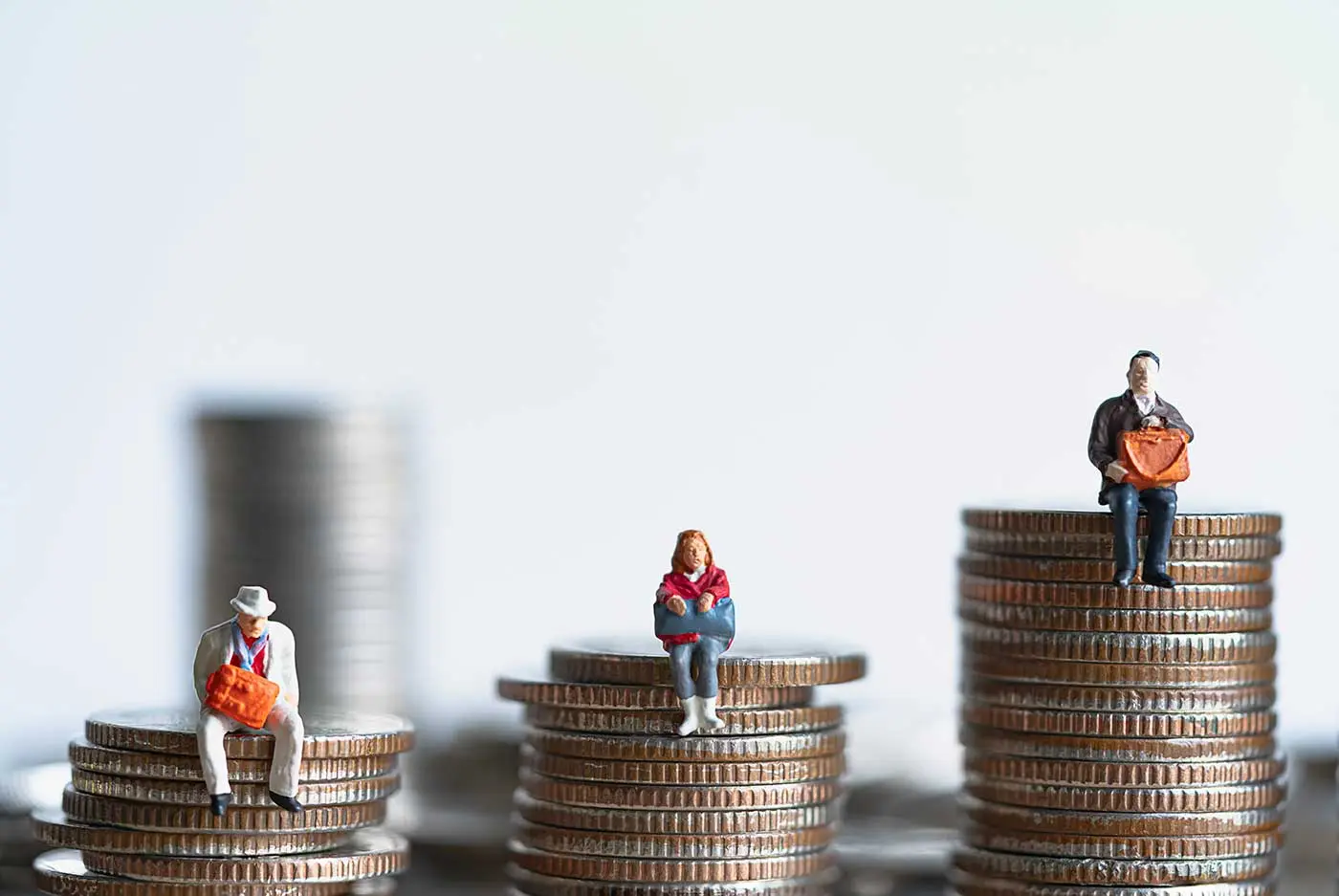 Miniature people: Elderly people sitting on coins stack. Retirement planning. money saving and Investment. Time counting down for retirement concept.