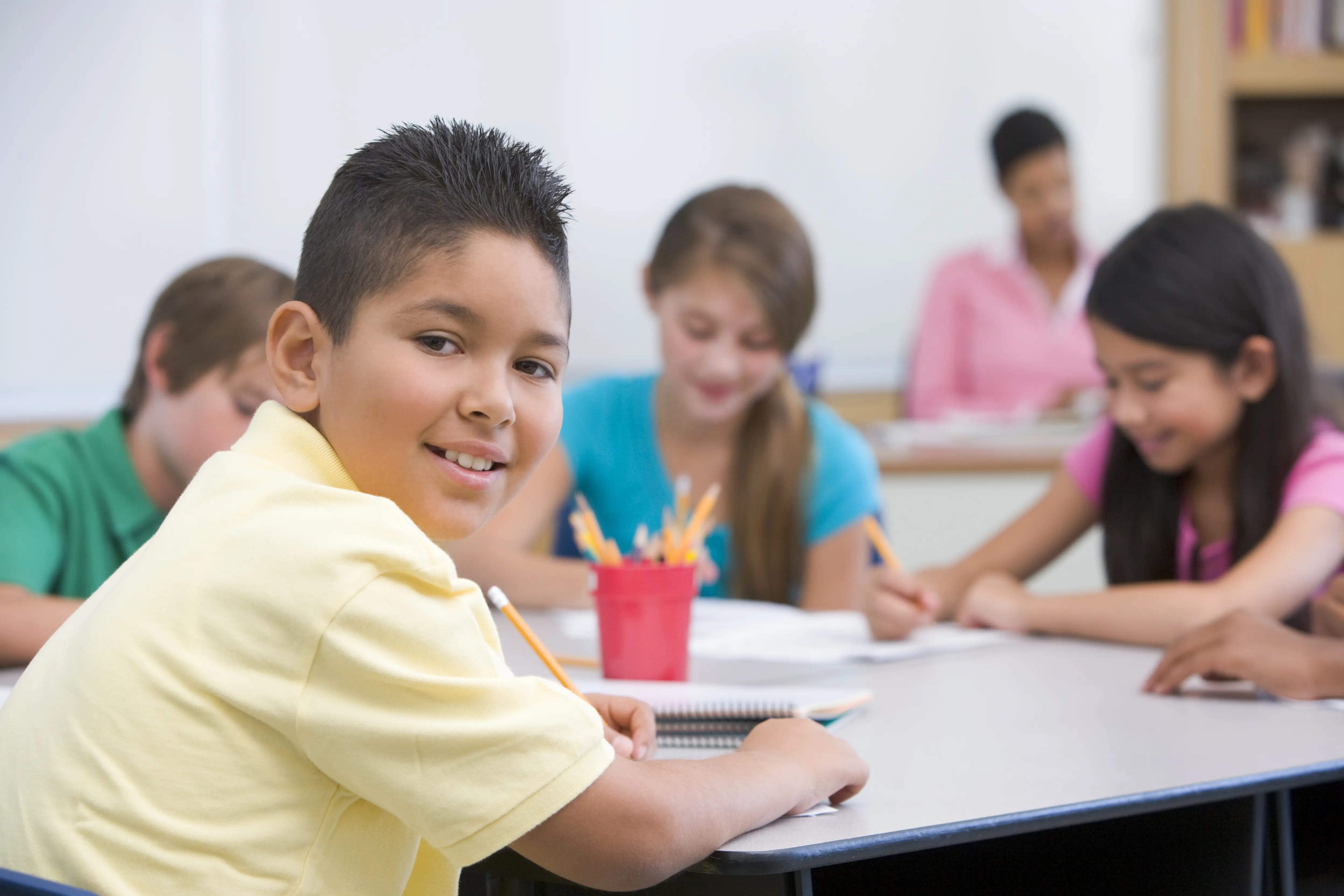 a boy is reading with his group