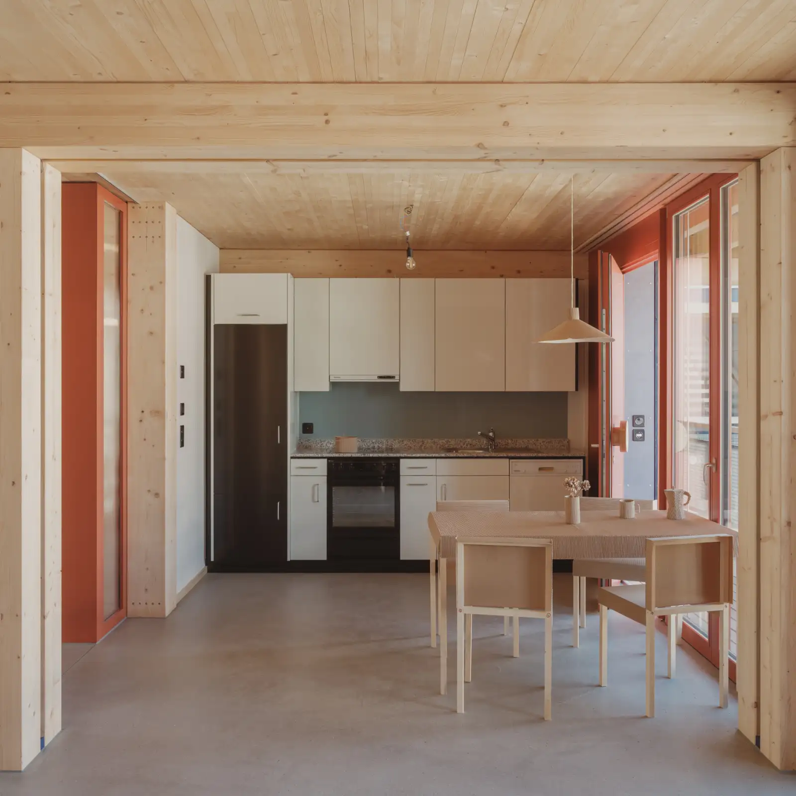Die Wohnungen mit minimalem Wohnflächenverbrauch nisten sich in eine flexible Holzstruktur ein. Wiederverwendete Küchen und sichtbar verschraubte Gipsfaserplatten werden zum Teil eines robusten Wohnerlebnisses.
