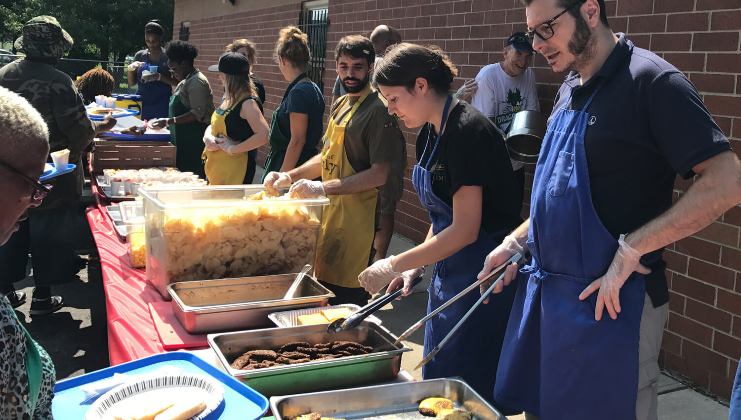 Students serving food to the homeless