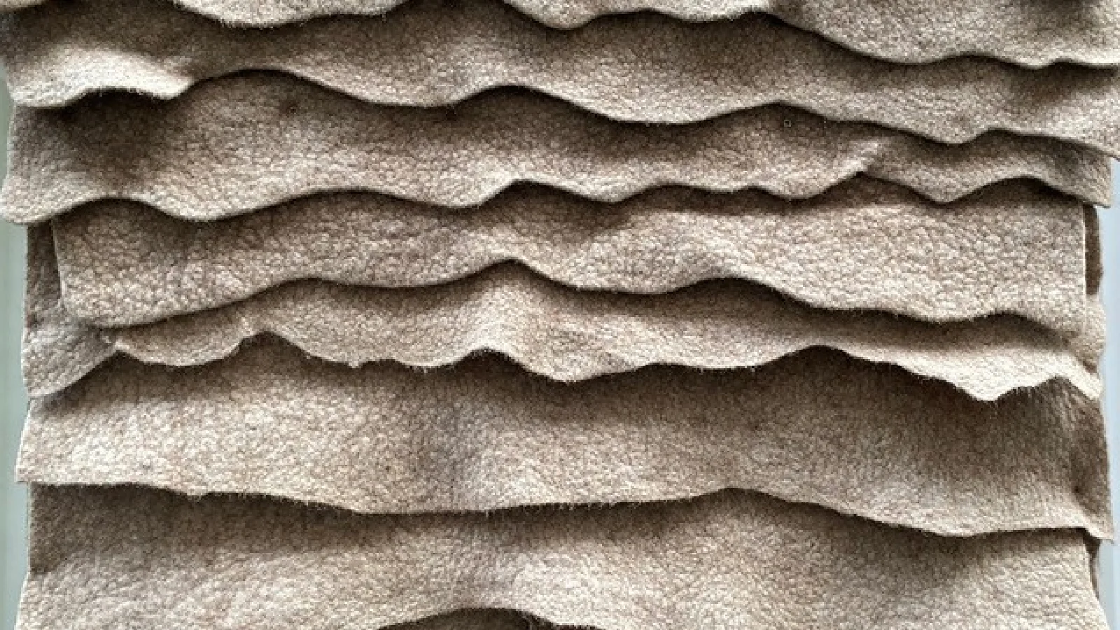 Felted sheep's wool that has been piled up.