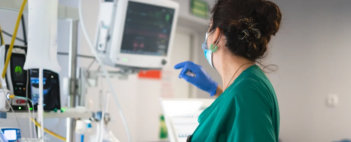 Nurse monitoring vital signs in intensive care unit