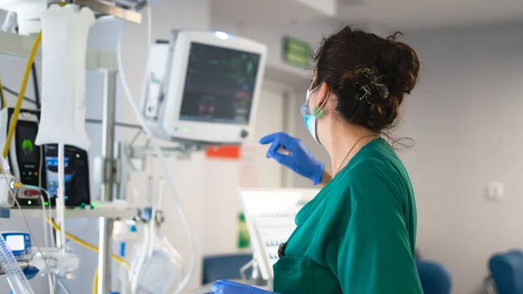 Nurse monitoring vital signs in intensive care unit