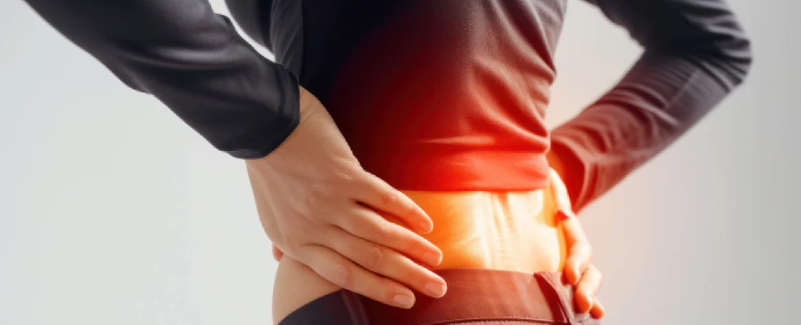 two hands holding the sides of the lower back